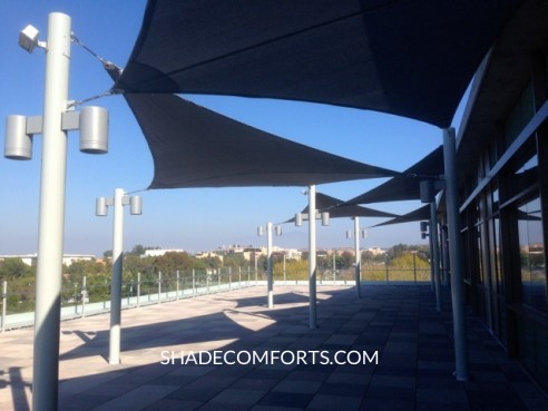 These custom shade sails are commercial-grade and cover the roof-top patio at an Orange County university.