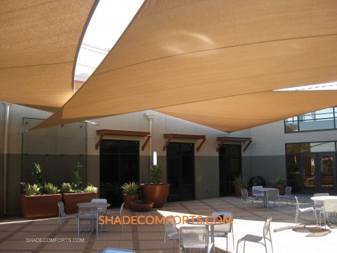 These custom patio shade sails secure to walls around a Sacramento commercial courtyard