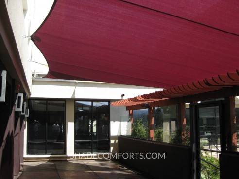 These custom patio shade sails cool outdoor diners at a San Francisco commercial restaurant.