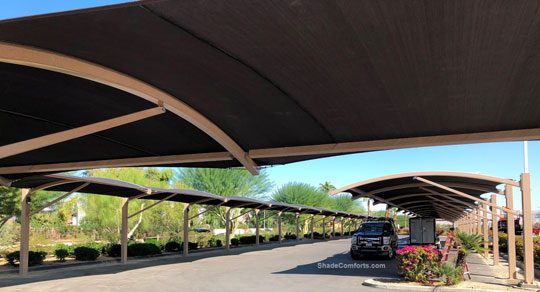 Car parking shade structures having arched cantilever beams in Inland Empire community of Coachella, CA in Riverside County.