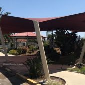 This shade sail structure cools passengers awaiting pick up at a San Diego bus stop. The posts lean outwards by 15 degrees.
