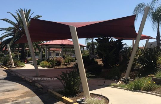 This shade sail structure cools passengers awaiting pick up at a San Diego bus stop. The posts lean outwards by 15 degrees.
