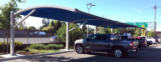 This car parking shade canopy is in Sonoma County, CA. The cantilevered beams are arched and project 18’ out from the posts. The structure is 60’ long.