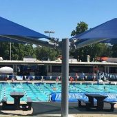 This permanent shade umbrella measures 20'x40'. Two pyramid roofs are on cantilevered beams projecting from a single column.