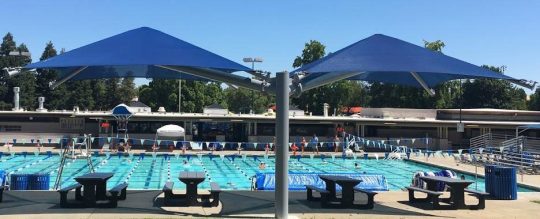 This permanent shade umbrella measures 20'x40'. Two pyramid roofs are on cantilevered beams projecting from a single column.