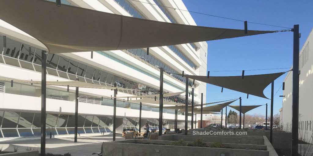 Commercial shade sails cool corporate patio.