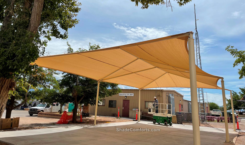 Two fabric shade canopies cool patios at Holloman Air Force Base in Alamogordo, New Mexico. Each has a single HDPE shade fabric spanning 50'x30' atop six posts.