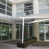 These fabric shade sails cover the front entrance to a San Francisco retail and office building. We secured wall plates to the concrete building with mechanical anchors.