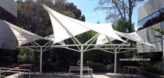 See photo of permanent hypar shade umbrellas on the courtyard patio between Santa Clara County office buildings. We designed and constructed these tensile structures.