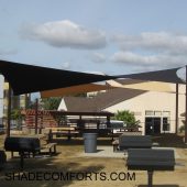 See photo of a tensile shade structure over a courtyard patio in Alameda County. Two hypar shade sails provide the protective cover.