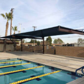 Tensioned fabric shade structure cools pool deck