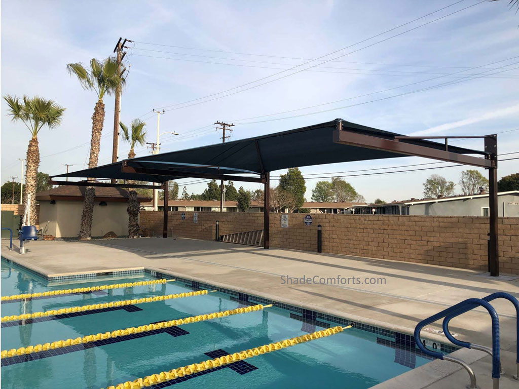 Tensioned fabric shade structure cools pool deck