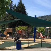 This shade sails structure cools the playground in the Marin County community of Corte Madera. Located at Town Park, it has (2) triangular sails supported by (5) posts.