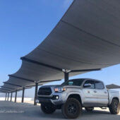 Tension fabric shade structure on parking garage rooftop