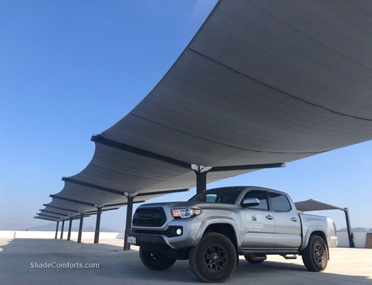 Tension fabric shade structure on parking garage rooftop