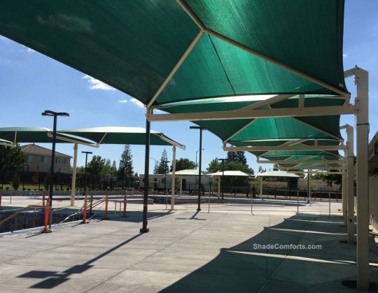 These fabric shade structures cool the aquatic center pool decks at Pat O’brien Community Center in Sacramento. Three structures collectively cool 4,475 square feet of hot pool deck.