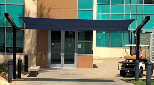 A cantilevered shade sail cools the front entrance at Kaiser Permanente Hospital in Riverside County, CA.