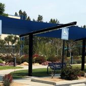These cantilevered shade sails cover the front walkway to a Riverside County, CA hospital. This photo is one of two structures measuring 56’ 6” x 14’. Each has 3 HDPE shade sails extended between 4 pairs of posts and beams.