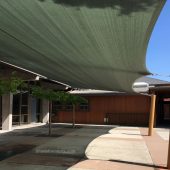 This shade sail structure cools the courtyard patio at Lafayette Orinda Presbyterian church in Contra Costa County. One HDPE shade fabric measuring 53’x22’ extends between the building and four posts