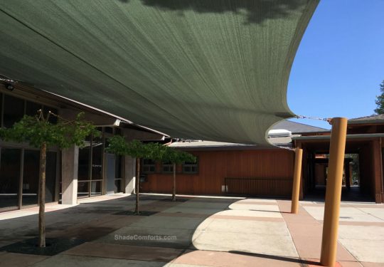 This shade sail structure cools the courtyard patio at Lafayette Orinda Presbyterian church in Contra Costa County. One HDPE shade fabric measuring 53’x22’ extends between the building and four posts
