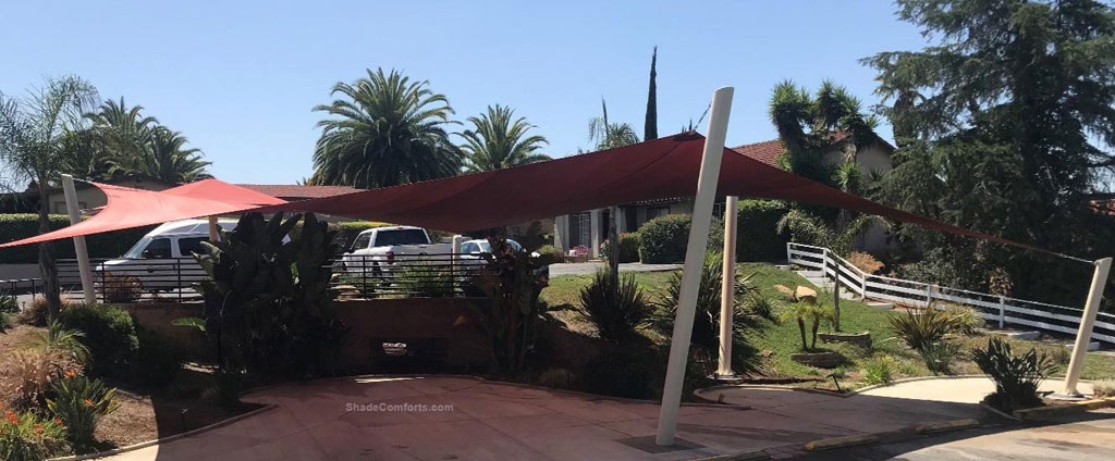 Passengers wait in cool comfort for shuttle buses and limousines underneath this shade sail structure.