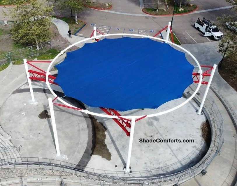 Tensile Membrane Structure that shades a playground that is under construction.