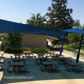 See photo of tensile shade structure covering the lunch patio at a San Francisco school. A single hypar fabric covers 1,638 square feet.