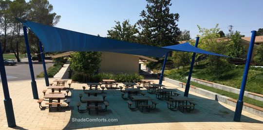 See photo of tensile shade structure covering the lunch patio at a San Francisco school. A single hypar fabric covers 1,638 square feet.
