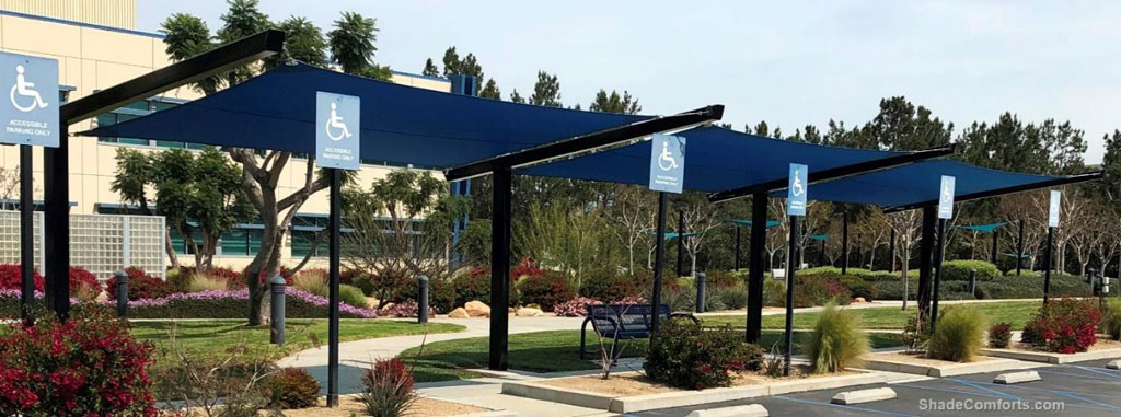 Three shade sail structures cool the front walkway and entrance to Kaiser Permanente in the Riverside County community of Corona, CA.  Single-plane shade sail extend between cantilevered beams.